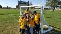 Kids Giving High Fives at a Soccer Goal